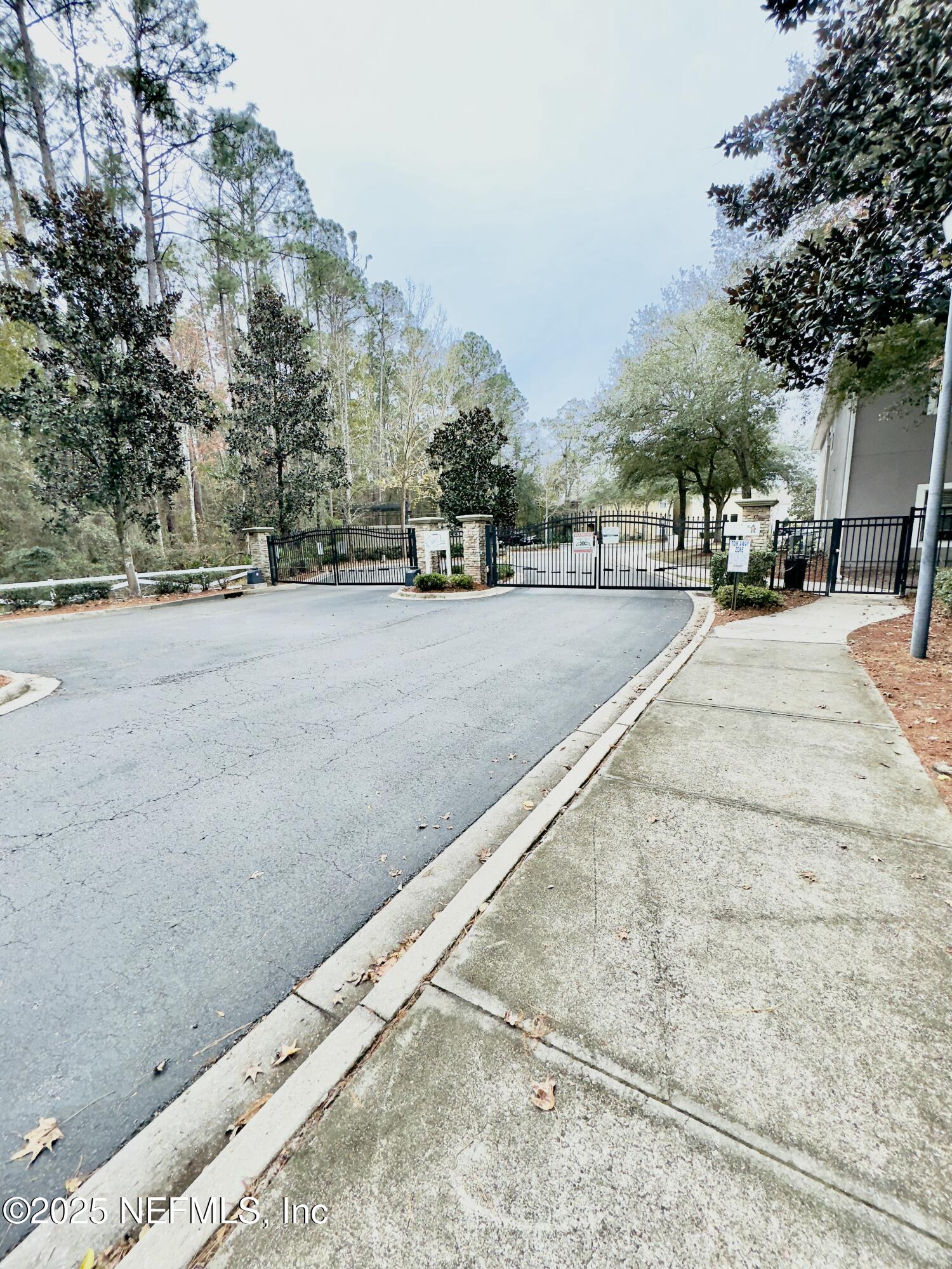 6057 Maggies Circle, Unit 114 Jacksonville, FL 32244 - Photo 2 of 28 a view of a street with a building and trees