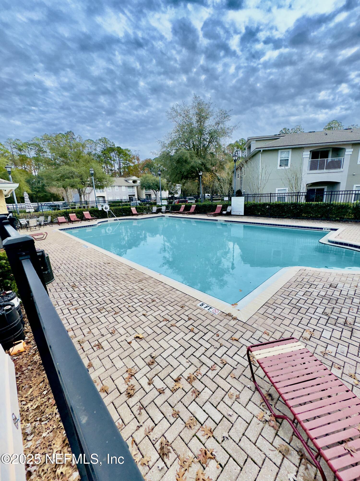 6057 Maggies Circle, Unit 114 Jacksonville, FL 32244 - Photo 21 of 28 a front view of a house with a yard