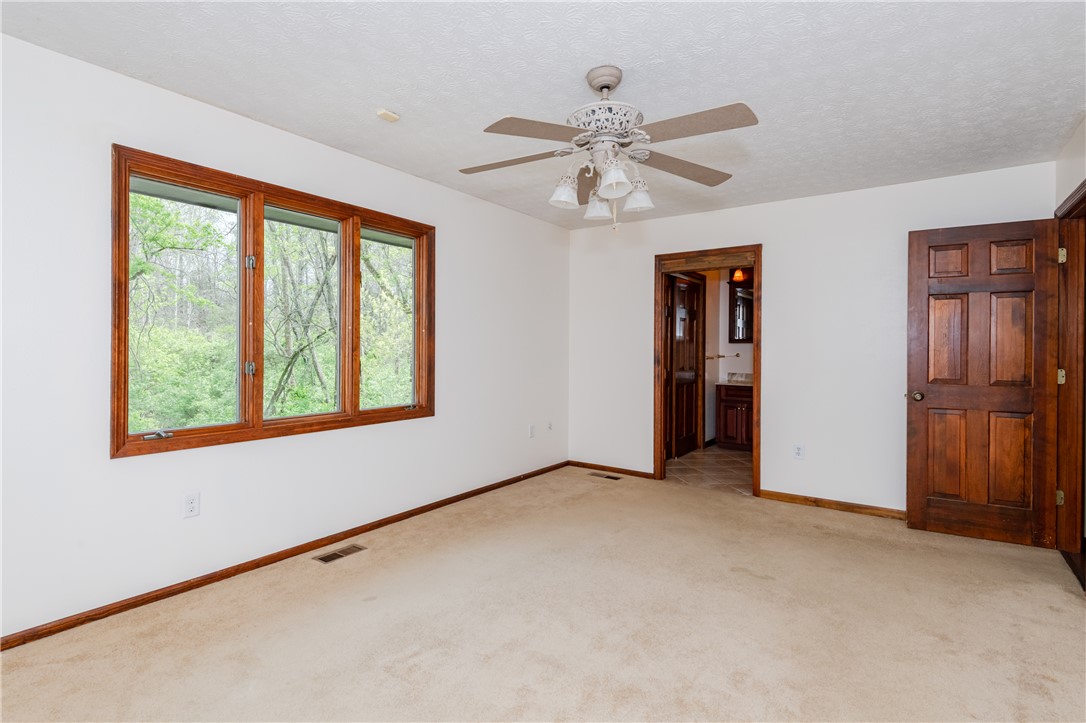 6750 Little Twin Road Germantown, OH 45327 - Photo 21 of 88 This airy bedroom offers serene views, providing a peaceful retreat with its connection to a private bathroom.
