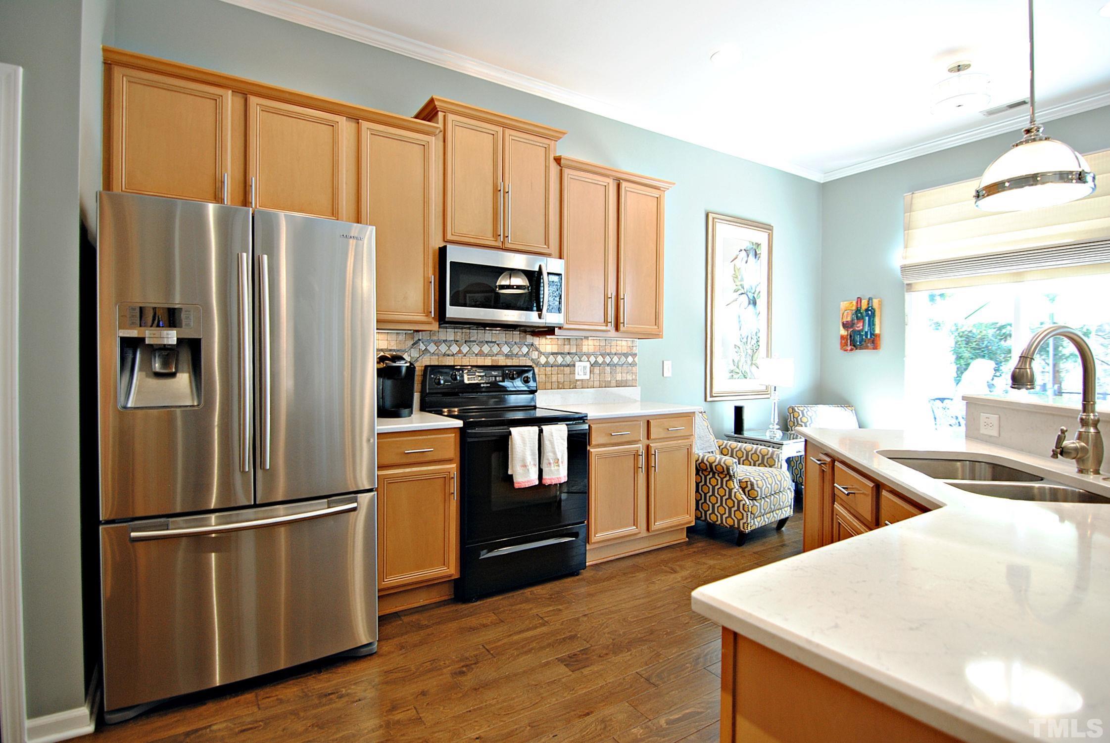13222 Ashford Park Drive Raleigh, NC 27613 - Photo 11 of 30 a kitchen with stainless steel appliances granite countertop a refrigerator stove microwave and sink