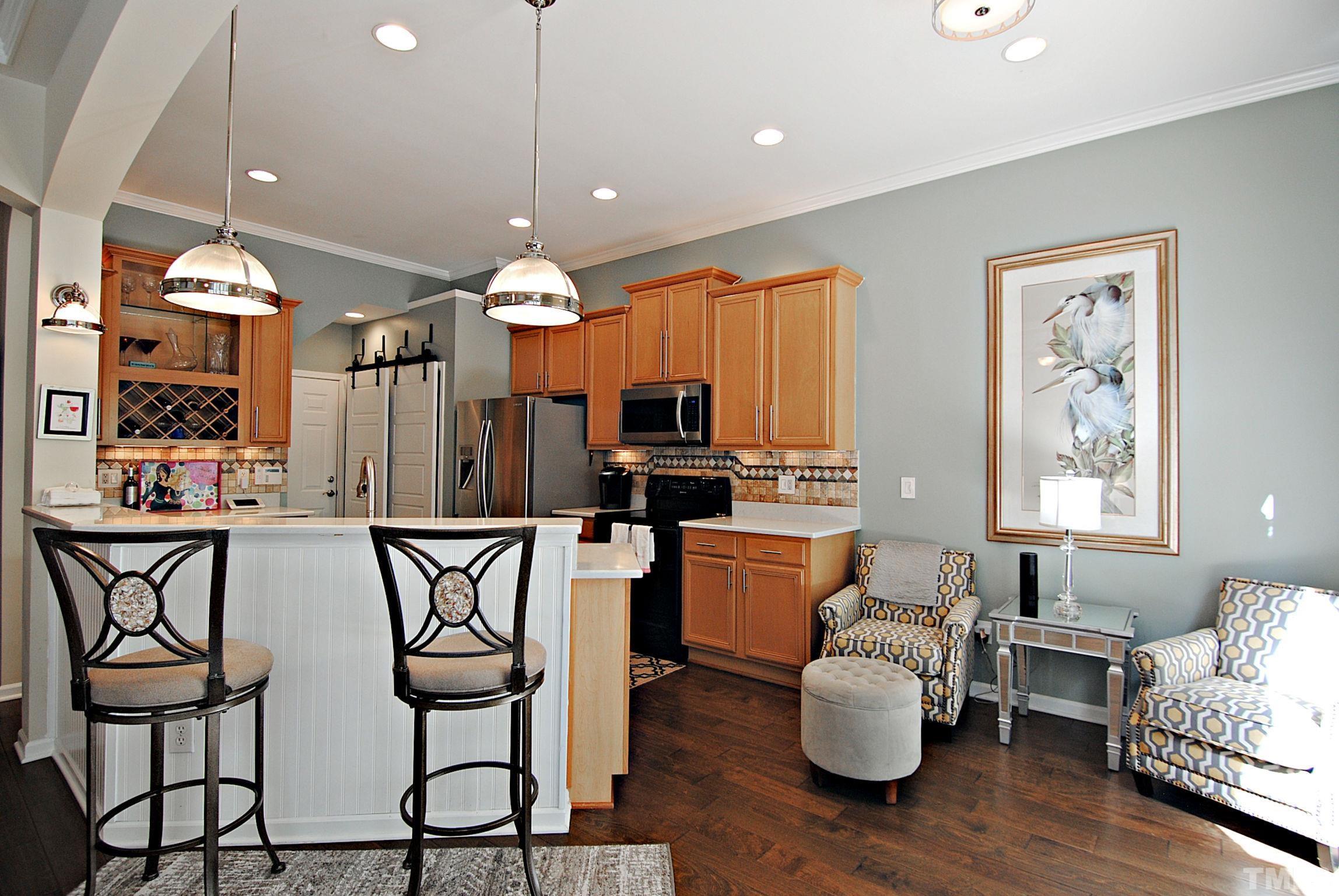 13222 Ashford Park Drive Raleigh, NC 27613 - Photo 13 of 30 a kitchen with stainless steel appliances granite countertop a stove top oven a sink dishwasher and white cabinets with wooden floor