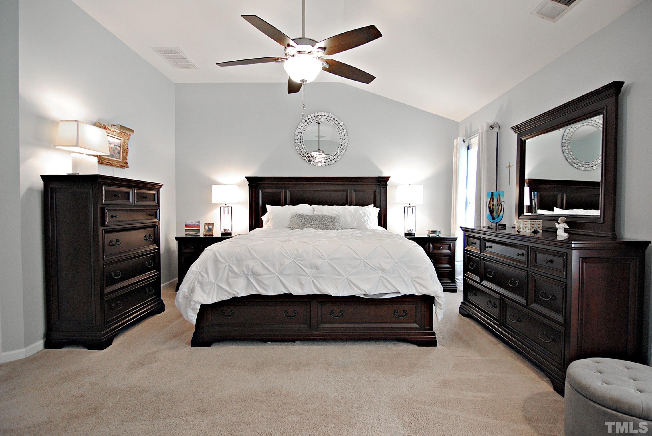 13222 Ashford Park Drive Raleigh, NC 27613 - Photo 15 of 30 a bedroom with a bed and a chandelier
