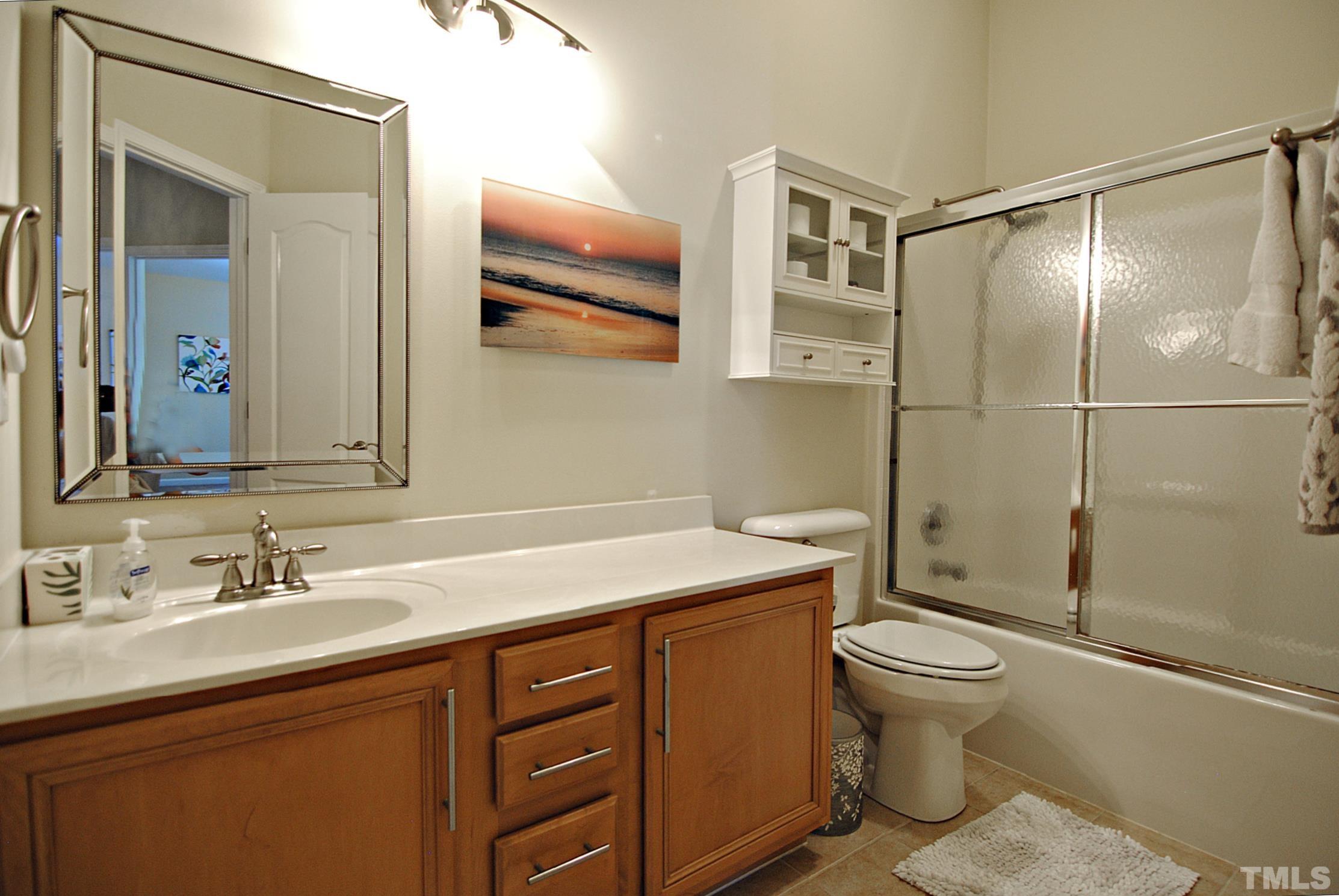 13222 Ashford Park Drive Raleigh, NC 27613 - Photo 21 of 30 a bathroom with a sink toilet and shower