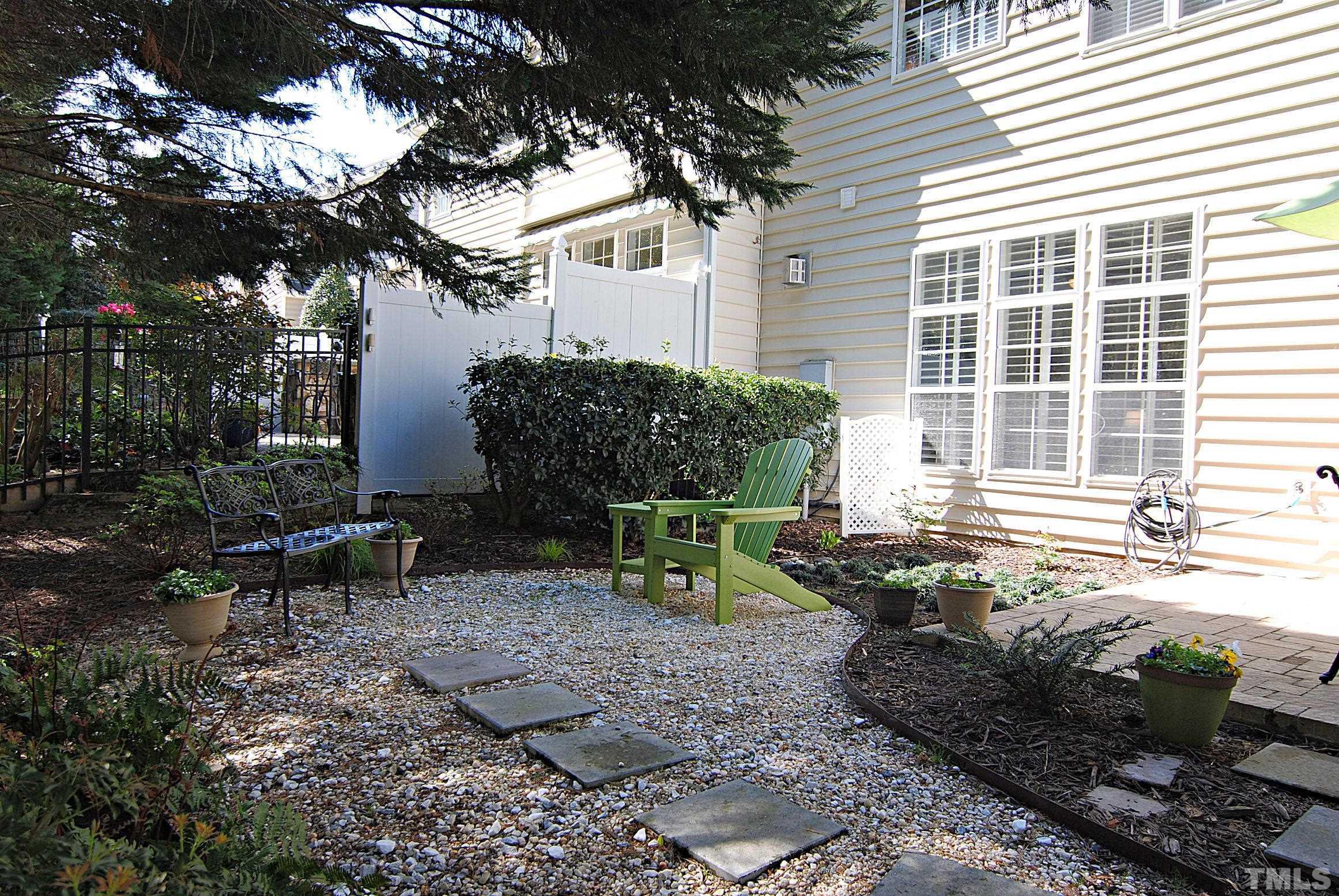 13222 Ashford Park Drive Raleigh, NC 27613 - Photo 23 of 30 a backyard of a house with table and chairs