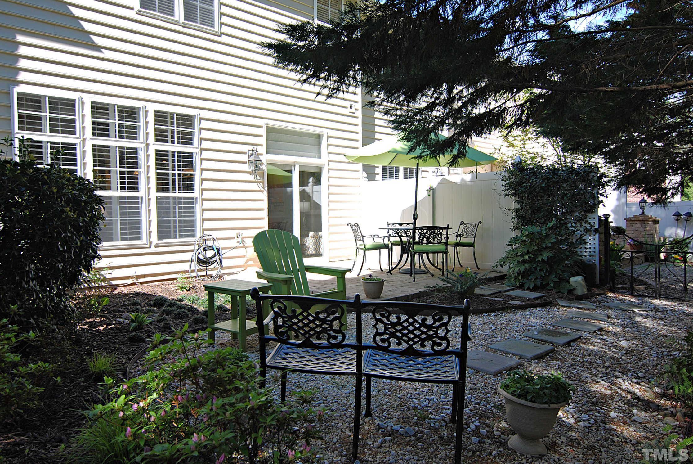 13222 Ashford Park Drive Raleigh, NC 27613 - Photo 24 of 30 a table and chairs in front of a house