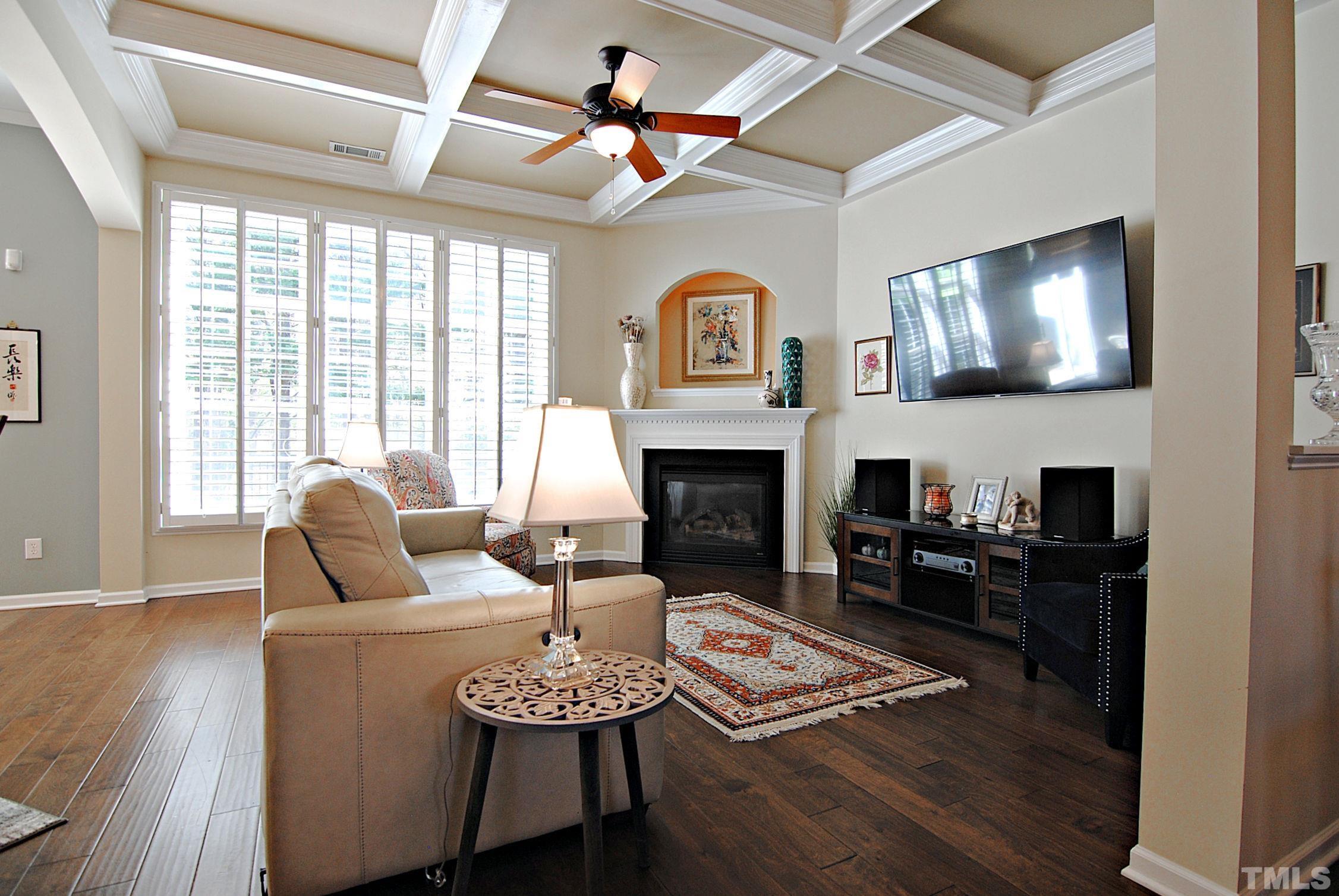 13222 Ashford Park Drive Raleigh, NC 27613 - Photo 7 of 30 a living room with furniture a fireplace and a flat screen tv