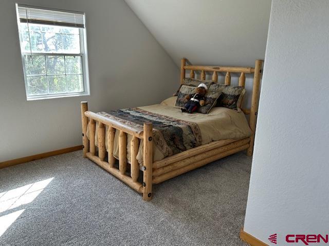 21330 Rd V.6 Lewis, CO 81327 - Photo 13 of 30 a bed sitting in a bedroom next to a window