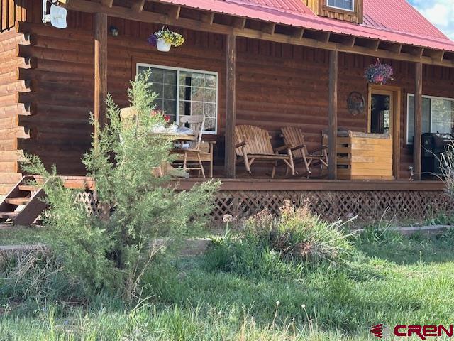 21330 Rd V.6 Lewis, CO 81327 - Photo 21 of 30 a view of a house with potted plants and a bench