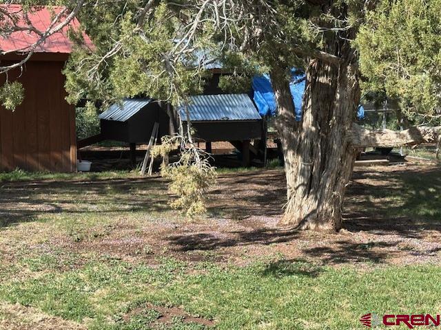 21330 Rd V.6 Lewis, CO 81327 - Photo 24 of 30 a view of a house with a tree in the yard