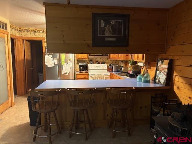 21330 Rd V.6 Lewis, CO 81327 - Photo 8 of 30 a kitchen with a sink a stove and wooden cabinets