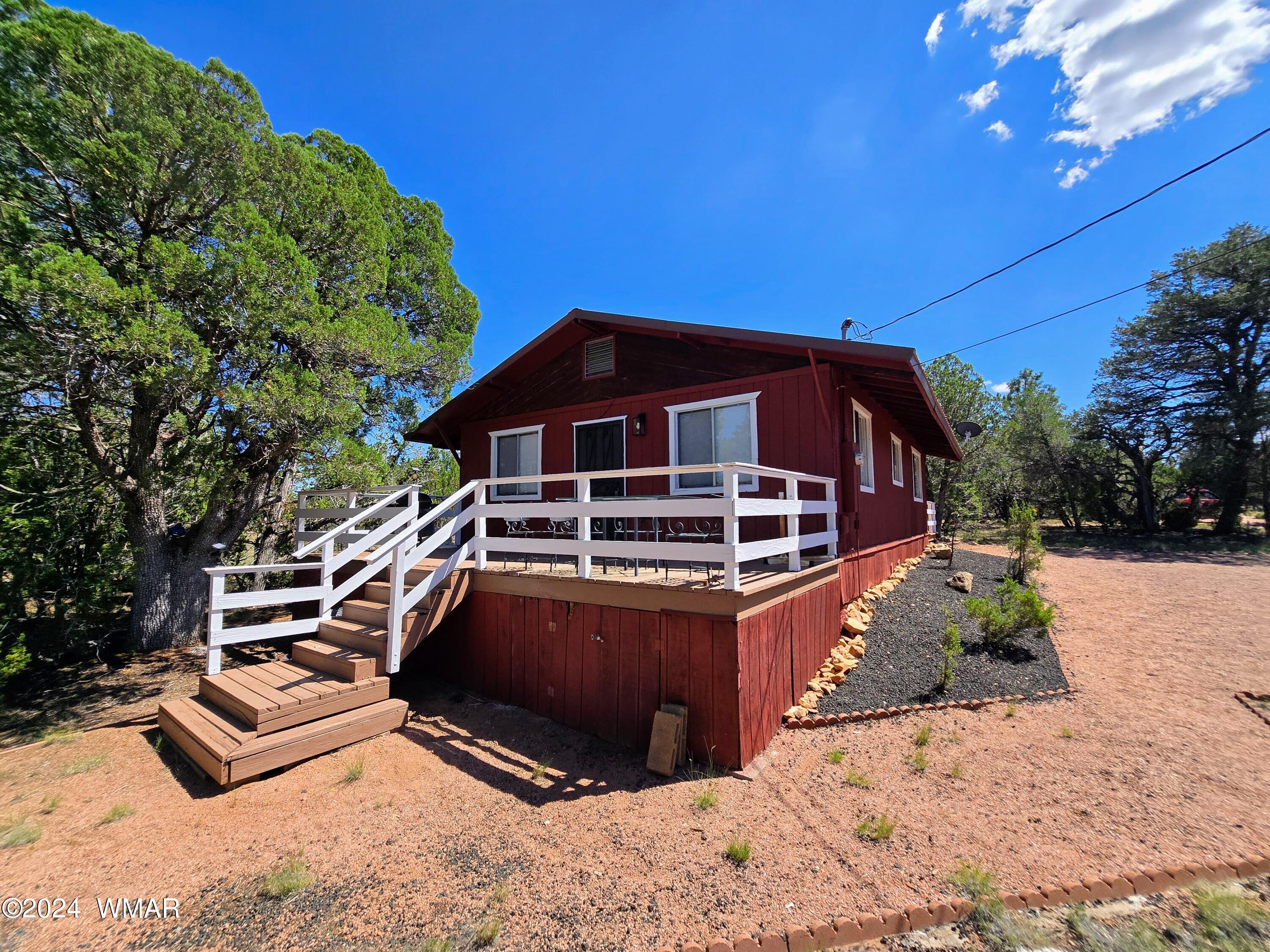 3058 Aspen Road Overgaard, AZ 85933 - Photo 11 of 15 a front view of a house with a yard