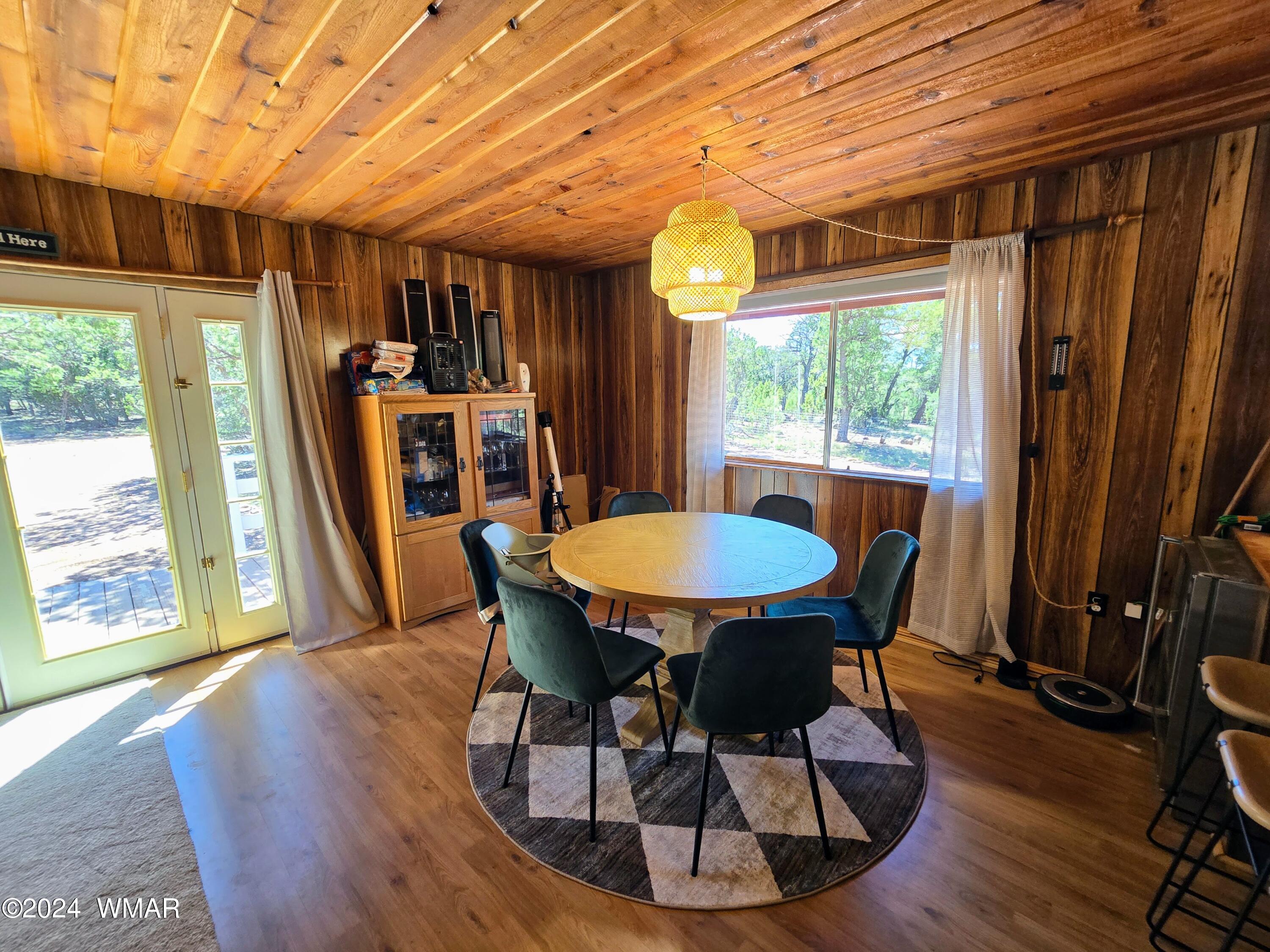 3058 Aspen Road Overgaard, AZ 85933 - Photo 10 of 15 a view of a dining room with furniture window and wooden floor