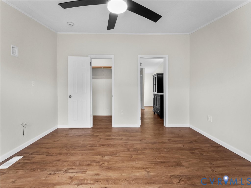 4772 Carsley Road Waverly, VA 23890 - Photo 15 of 38 Unfurnished bedroom with a spacious closet, wood f