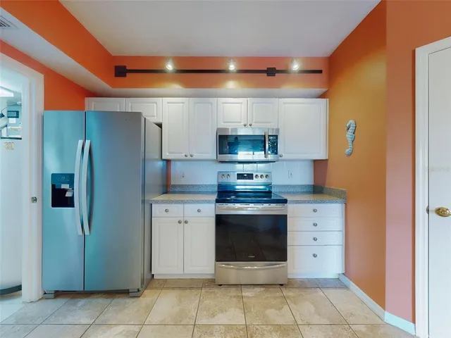 a room with table and paintings on the wall