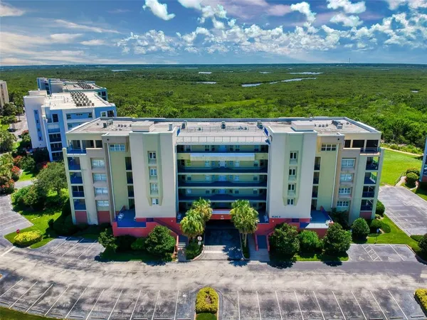 a view of a dining room with furniture a chandelier and wooden floor