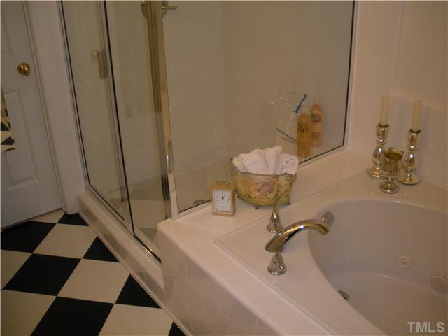 7409 Fontana Ridge Lane Raleigh, NC 27613 - Photo 18 of 25 Dual Master Bedrooms! One Owner Suite is on the first level with a shower and tub. The second Owner Suite is on the second level. There are ample closets throughout this beautiful house. Attic storage too! Master Bedroom