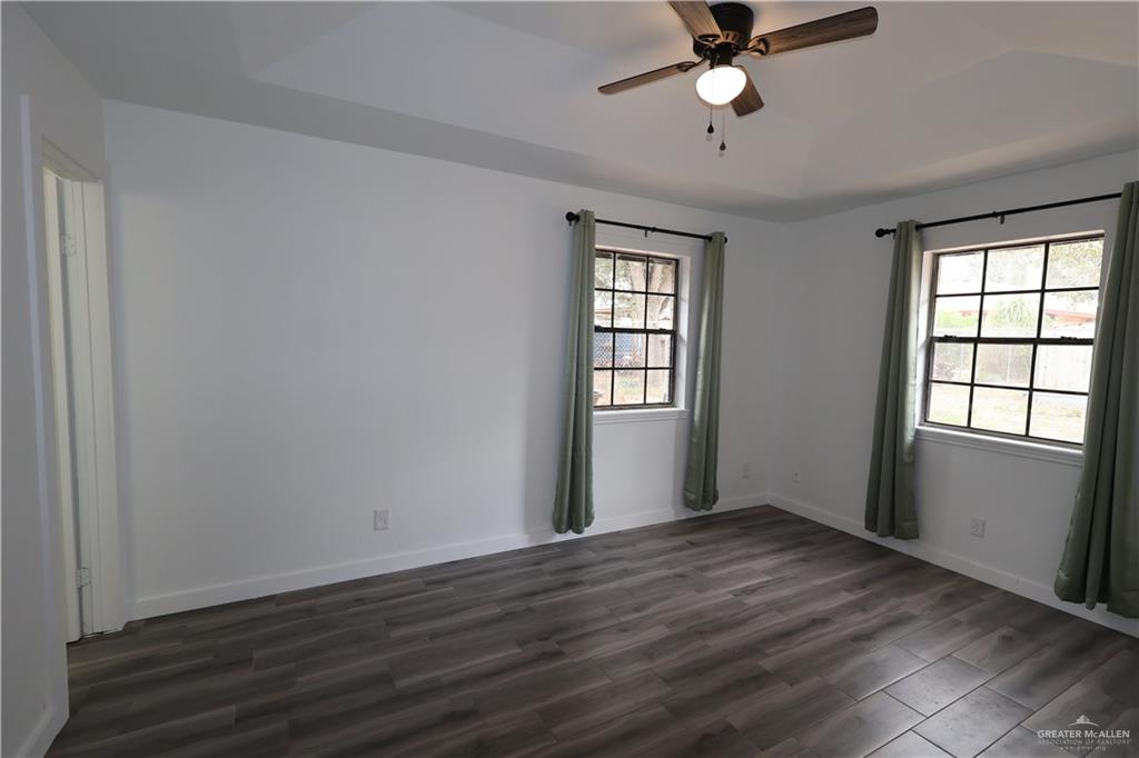 3526 Paseo Del Rey Edinburg, TX 78542 - Photo 11 of 20 Empty room with dark wood-style floors and ceiling fan