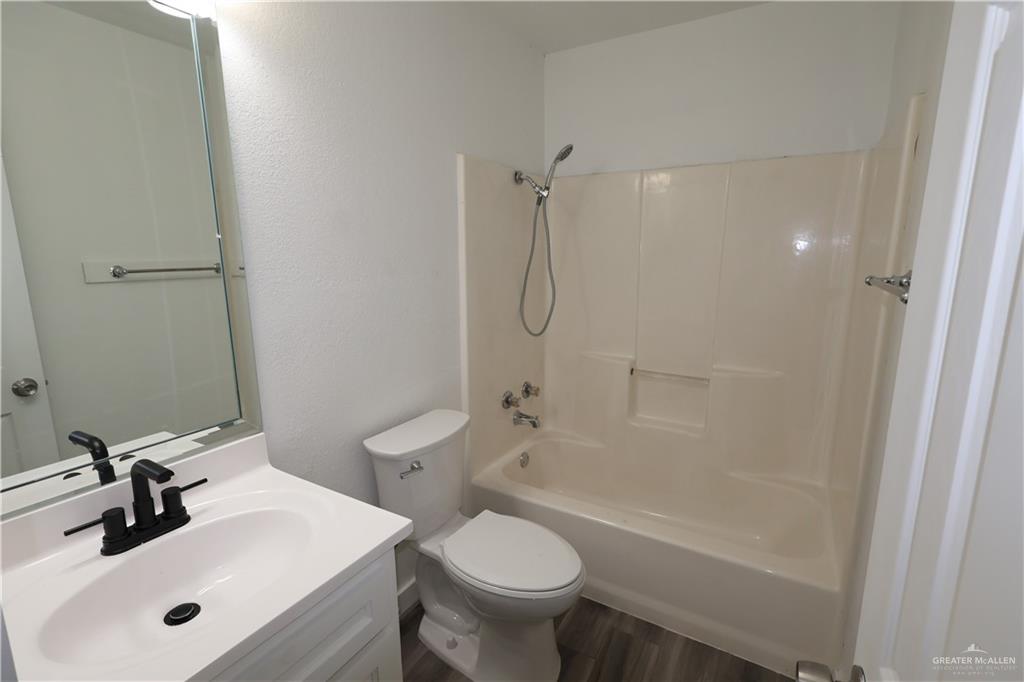 3526 Paseo Del Rey Edinburg, TX 78542 - Photo 13 of 20 Bathroom featuring vanity, shower / bathtub combination, and wood finished floors