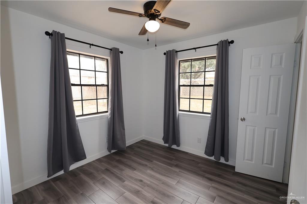 3526 Paseo Del Rey Edinburg, TX 78542 - Photo 14 of 20 Unfurnished room featuring dark wood-type flooring and a ceiling fan