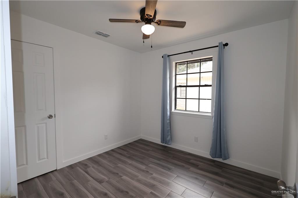 3526 Paseo Del Rey Edinburg, TX 78542 - Photo 7 of 20 Unfurnished room with wood finished floors and a ceiling fan