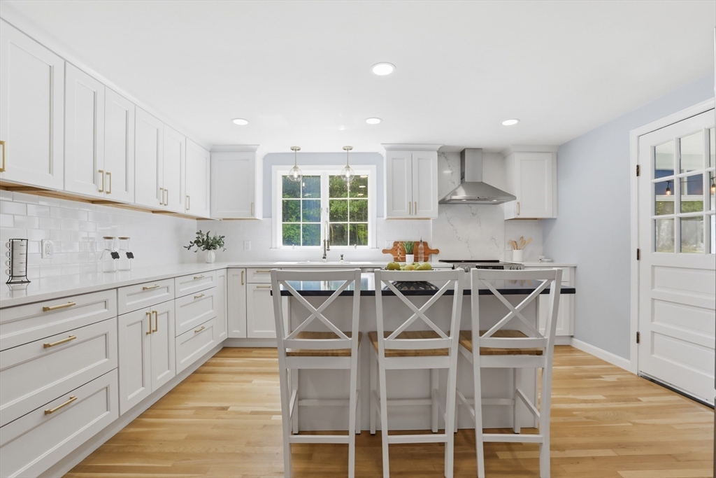 94 Johnson Road Winchester, MA 01890 - Photo 4 of 40 a kitchen with stainless steel appliances kitchen island granite countertop a sink and cabinets