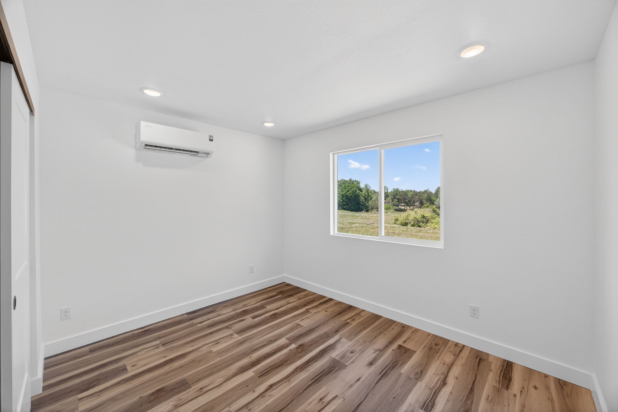116 Bill Storie Road Byrdstown, TN 38549 - Photo 16 of 32 wooden floor in an empty room with a window