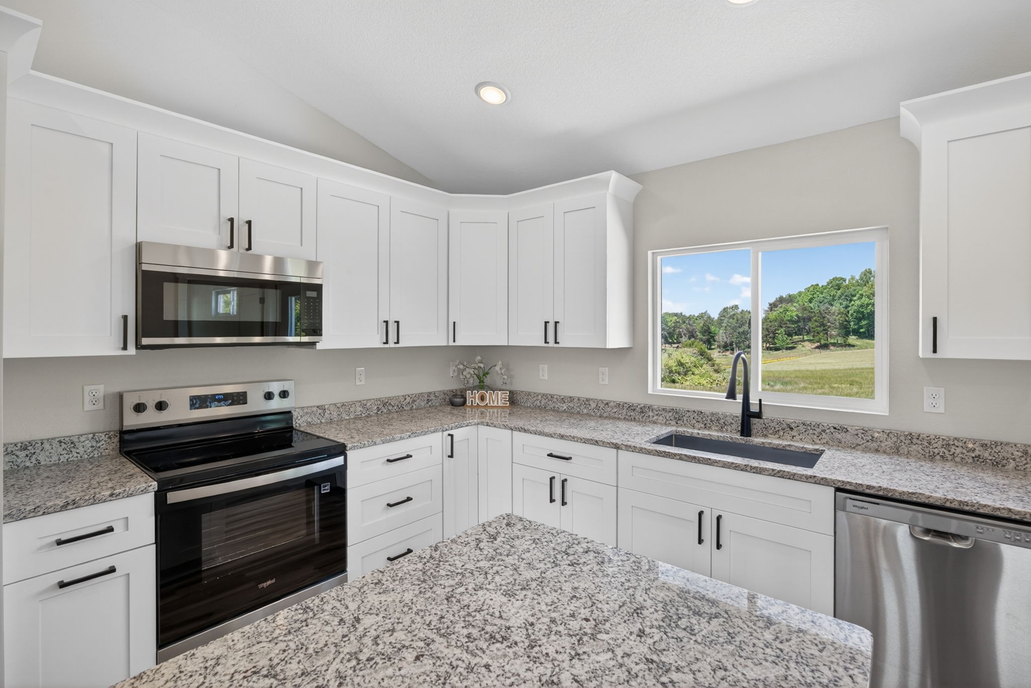 116 Bill Storie Road Byrdstown, TN 38549 - Photo 5 of 32 a kitchen with granite countertop a stove sink and microwave