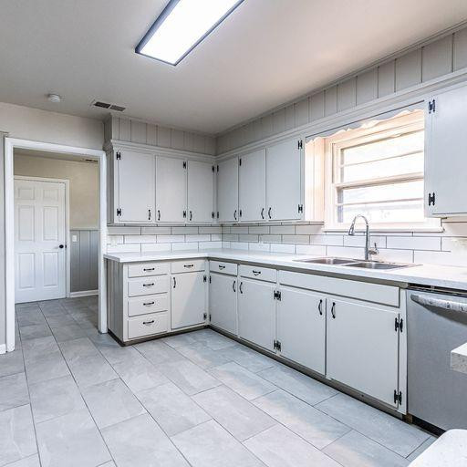 2110 65th Street Lubbock, TX 79412 - Photo 15 of 37 a kitchen with a sink window and cabinets