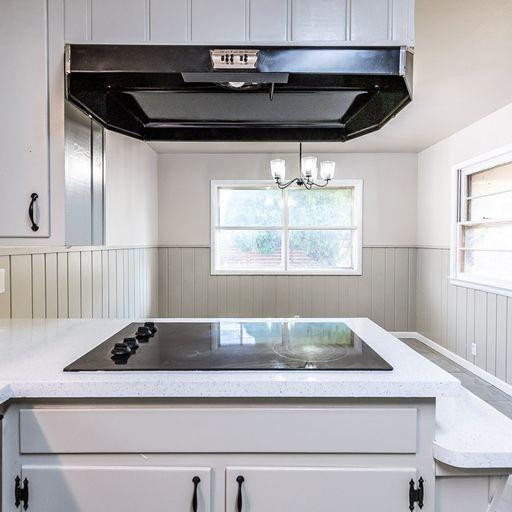 2110 65th Street Lubbock, TX 79412 - Photo 19 of 37 a bathroom with a bathtub and chandelier