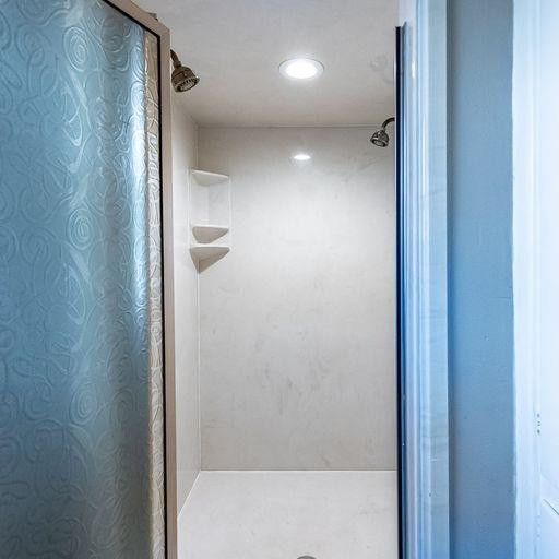 2110 65th Street Lubbock, TX 79412 - Photo 26 of 37 a bathroom with a shower and a glass door