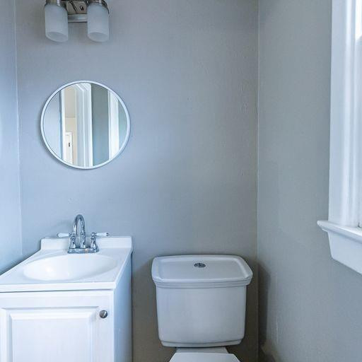 2110 65th Street Lubbock, TX 79412 - Photo 27 of 37 a bathroom with a sink mirror and toilet