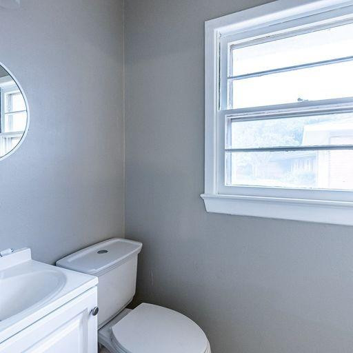 2110 65th Street Lubbock, TX 79412 - Photo 28 of 37 a white toilet sitting next to a window