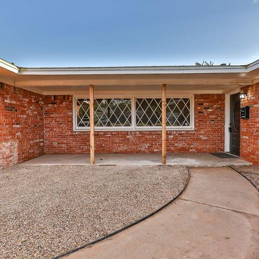 2110 65th Street Lubbock, TX 79412 - Photo 3 of 37 wooden floor with a view of a porch