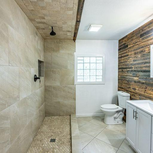 2110 65th Street Lubbock, TX 79412 - Photo 32 of 37 a bathroom with a toilet a sink a shower and a window