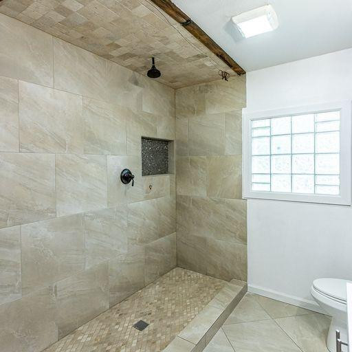2110 65th Street Lubbock, TX 79412 - Photo 33 of 37 a bathroom with a shower and a toilet