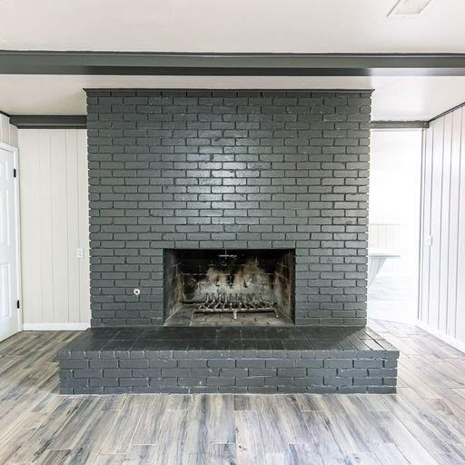 2110 65th Street Lubbock, TX 79412 - Photo 7 of 37 a fireplace with a wooden floor