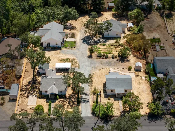 an aerial view of multiple houses with yard