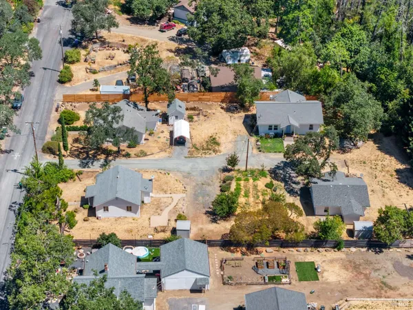 an aerial view of residential houses with outdoor space