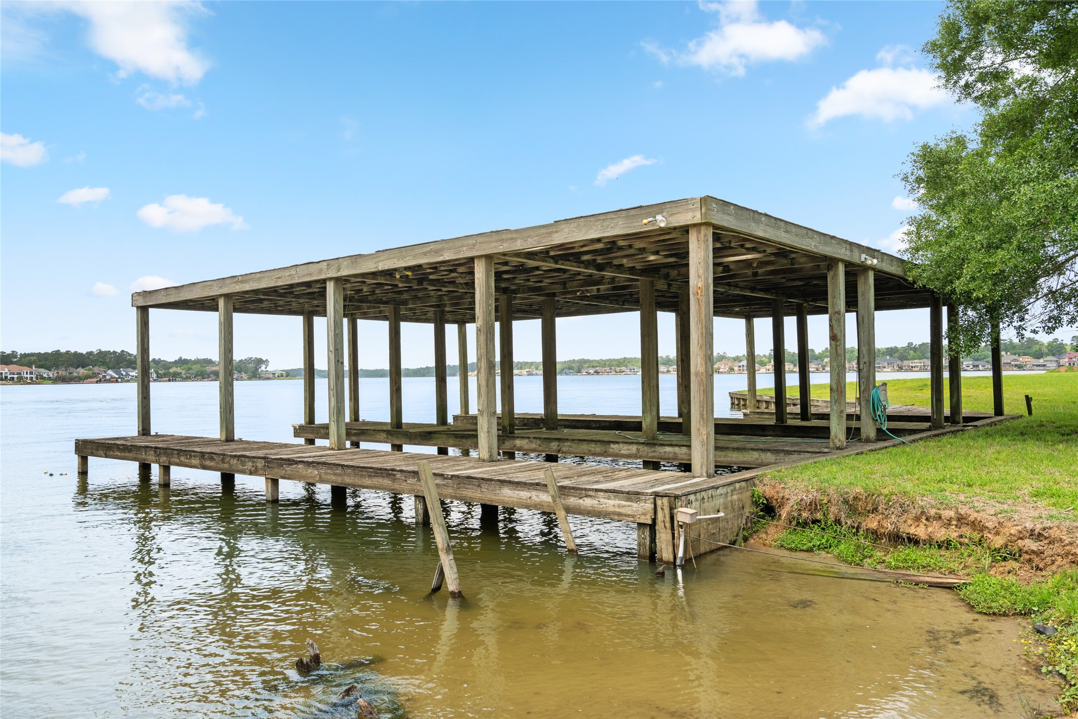 15126 Walden Road Montgomery, TX 77356 - Photo 10 of 50 Three slip wooden boathouse on property- convenient, protected docking with classic waterfront character.
