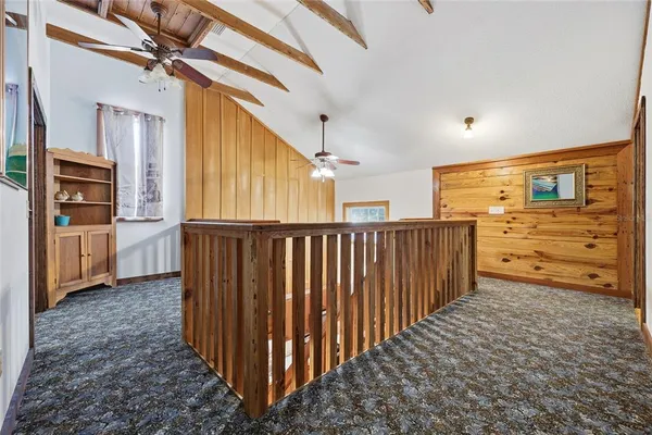 a view of hallway with wooden floor and windows