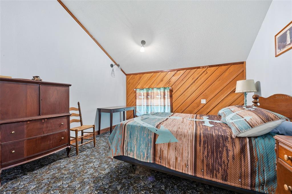 317 Cedar Street Steinhatchee, FL 32359 - Photo 15 of 32 a bedroom with a bed and wooden floor