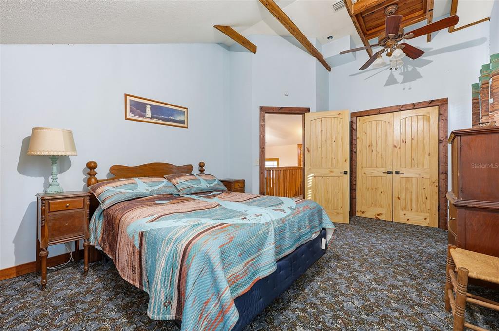 317 Cedar Street Steinhatchee, FL 32359 - Photo 16 of 32 a bedroom with bed a lamp and a window