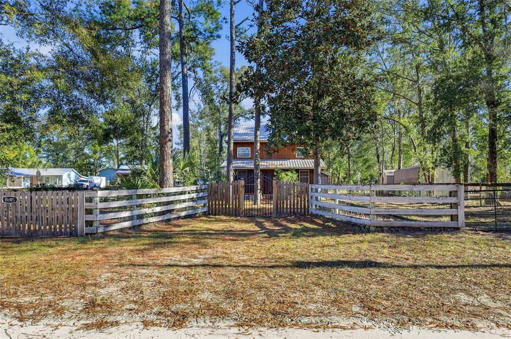 317 Cedar Street Steinhatchee, FL 32359 - Photo 2 of 32 a view of a house with pool and trees in the background