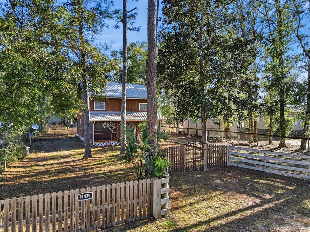 317 Cedar Street Steinhatchee, FL 32359 - Photo 26 of 32 a view of a street with wooden fence