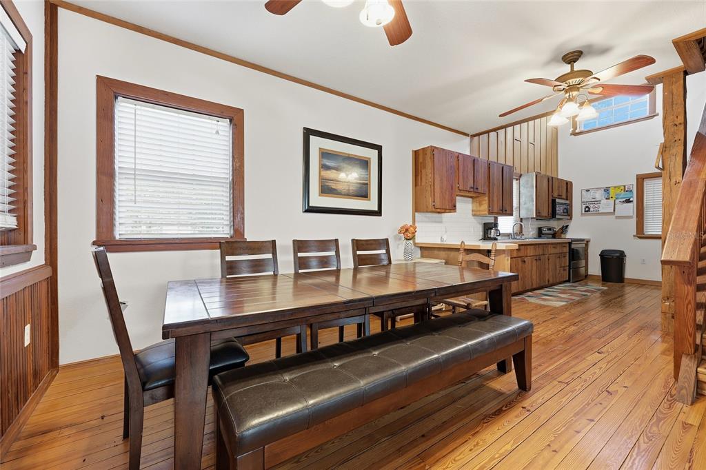 317 Cedar Street Steinhatchee, FL 32359 - Photo 8 of 32 a view of a dining room with furniture and wooden floor