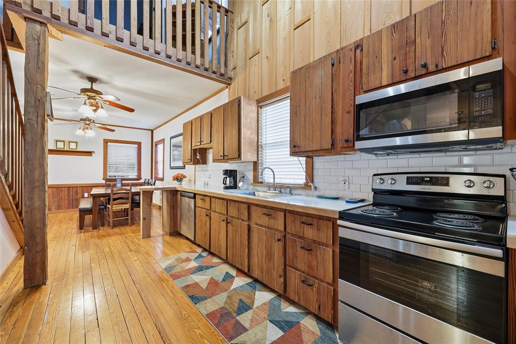 317 Cedar Street Steinhatchee, FL 32359 - Photo 9 of 32 a kitchen with stainless steel appliances a stove a microwave and cabinets
