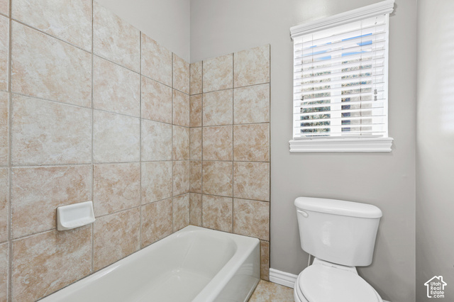 14038 New Saddle Road Draper, UT 84020 - Photo 20 of 46 White porcelain bathtub with a ceramic tile surround and a toilet
