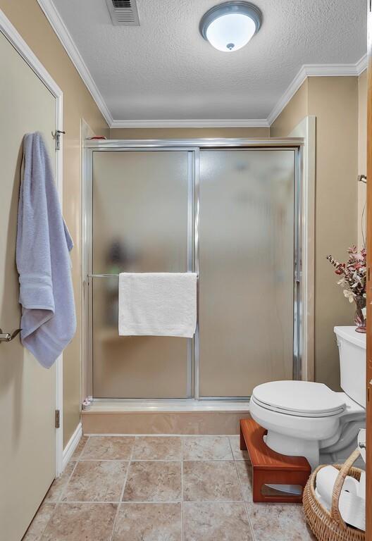 1065 Dendron Drive Hewitt, TX 76643 - Photo 18 of 32 a bathroom with a toilet and a shower