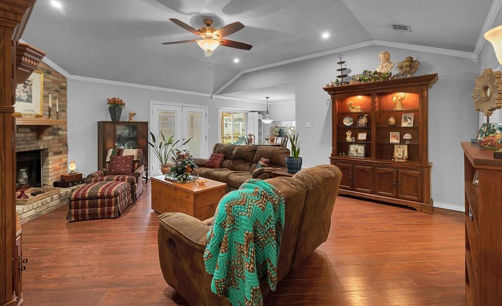 1065 Dendron Drive Hewitt, TX 76643 - Photo 5 of 32 a living room with furniture a fireplace and a flat screen tv