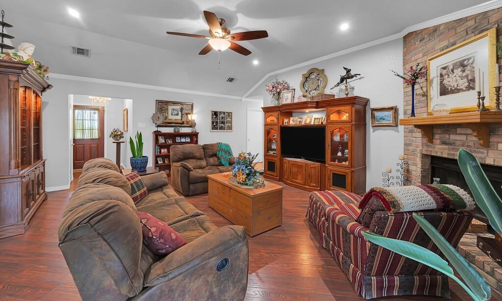 1065 Dendron Drive Hewitt, TX 76643 - Photo 6 of 32 a living room with furniture a flat screen tv and a fireplace